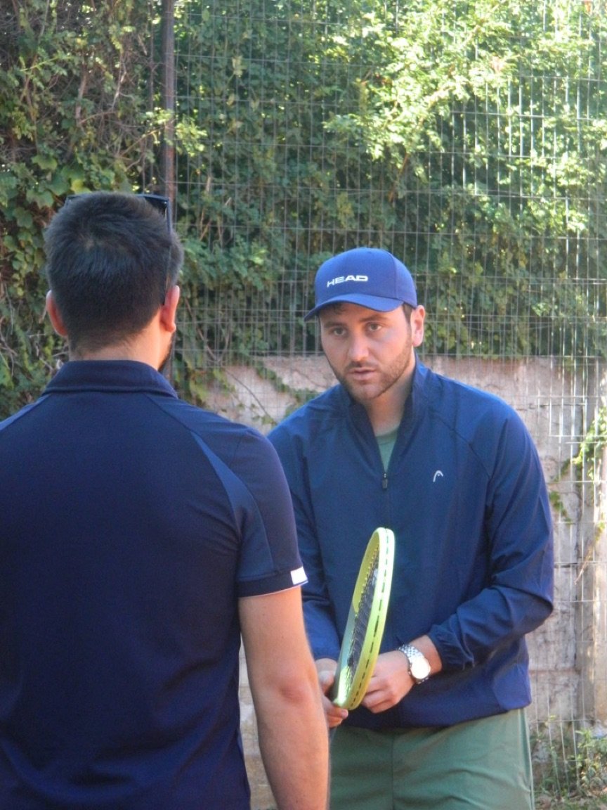 Entrenamiento en cancha entre entrenador y jugador en Match Point